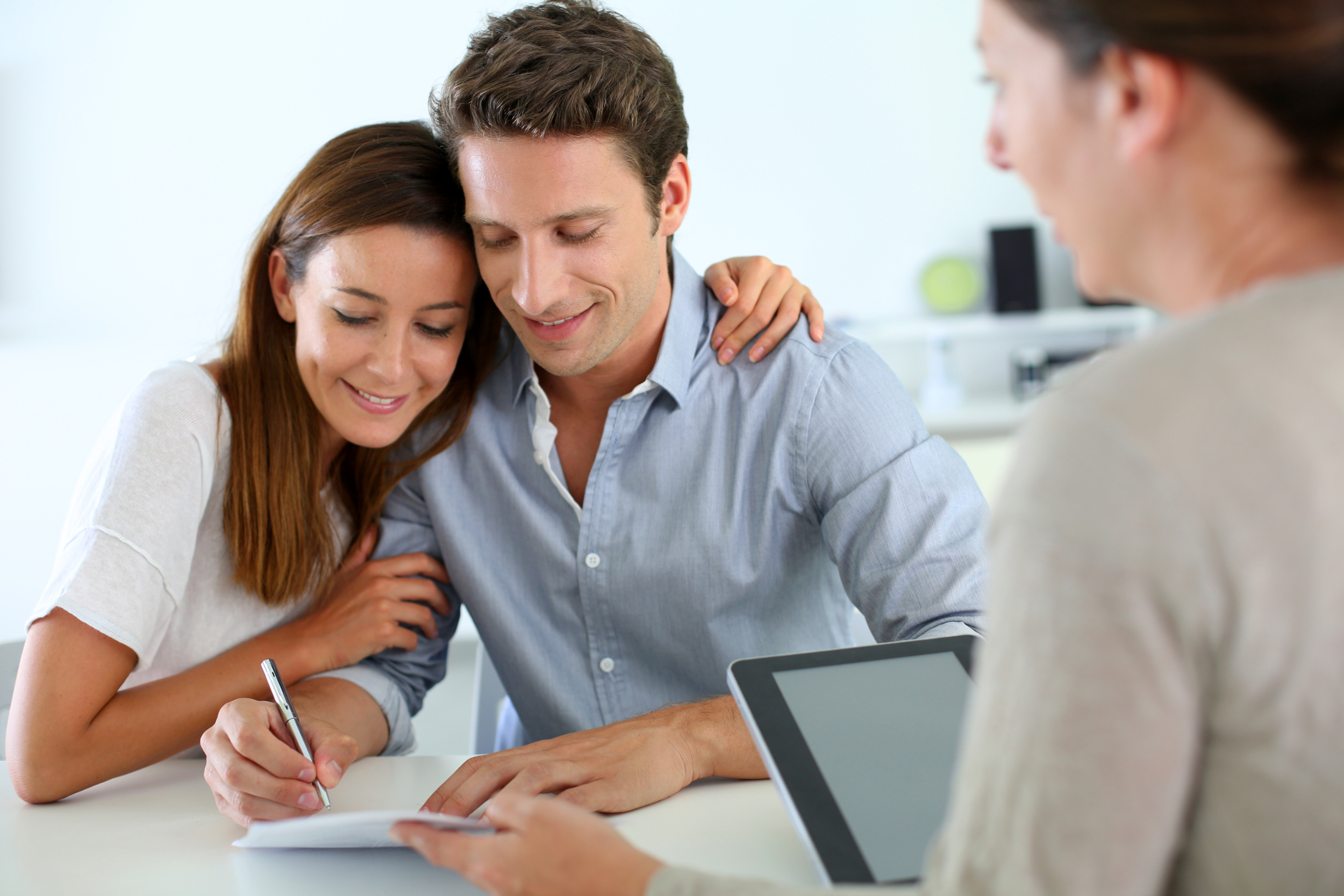 A young couple meeting with a mortgage lender